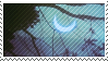 stamp with a blue crescent moon against a turquoise sky, visible behind tree branches